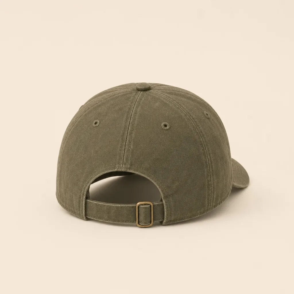 Back view of the faded-olive Trail Canvas Cap showing its brass strap adjuster